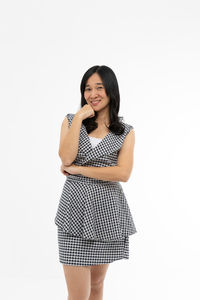 Portrait of a smiling young woman against white background