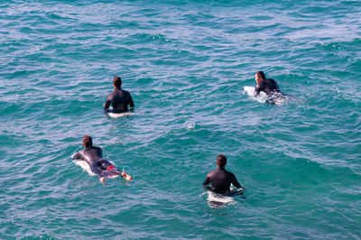 High angle view of men swimming in sea