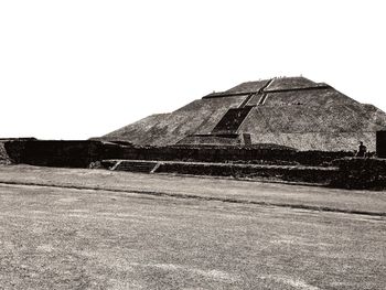 View of built structure on field against clear sky
