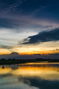 Scenic view of lake against sky during sunset
