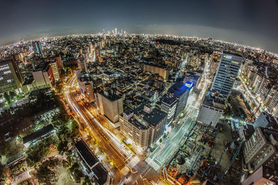 High angle view of city lit up at night