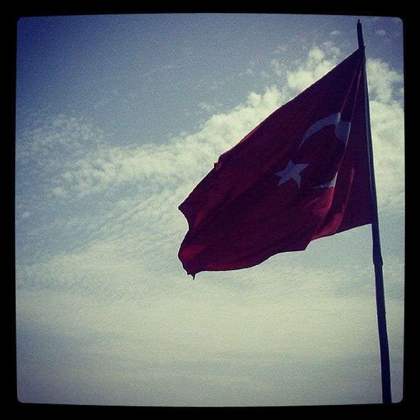 transfer print, sky, low angle view, flag, identity, auto post production filter, patriotism, cloud, red, national flag, cloud - sky, wind, no people, outdoors, nature, american flag, day, beauty in nature, pole, blue