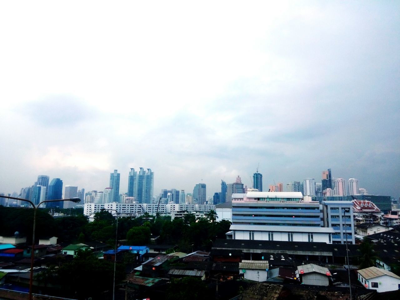 building exterior, architecture, built structure, city, sky, skyscraper, cloud, cloud - sky, tall - high, modern, urban skyline, office building, cityscape, tower, development, growth, cloudy, day, building story, outdoors, financial district, city life, tall, skyline, residential district, no people