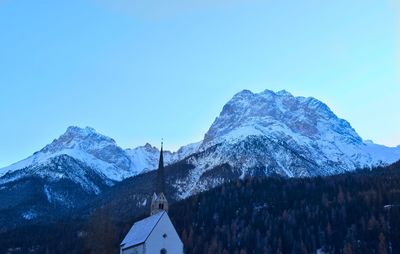 Scenic view of snowcapped mountains against clear blue sky