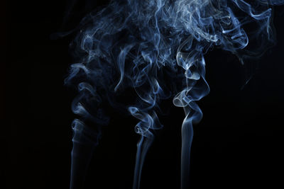 Close-up of smoke emitting from black background