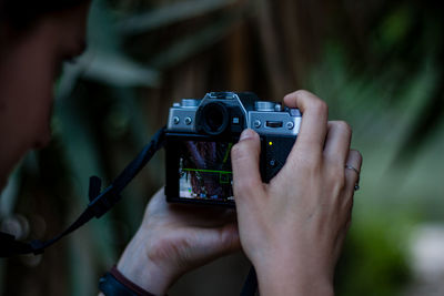 Close-up of woman photographing with camera