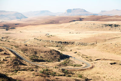 Scenic view of arid landscape against sky