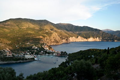 High angle view of lake and mountains against sky