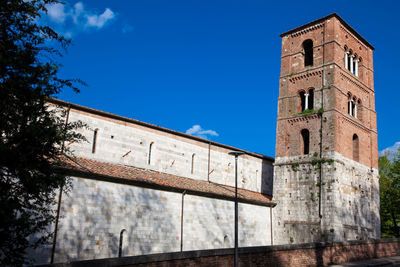 Low angle view of old building against blue sky