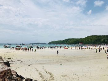 People on beach against sky