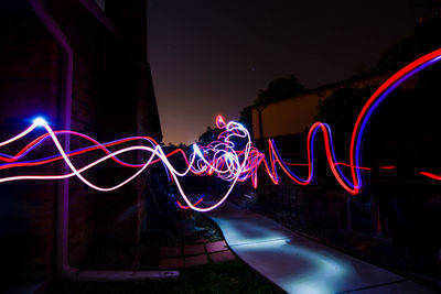 Light painting of graffiti on building at night