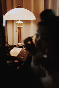 Close-up portrait of woman reading book at home