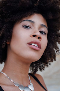 Close-up portrait of afro teenage girl at home