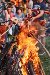 People preparing food on bonfire