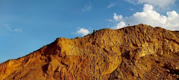 Low angle view of rock formations against sky