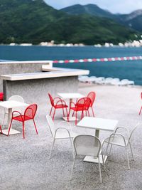 Empty chairs and tables in swimming pool