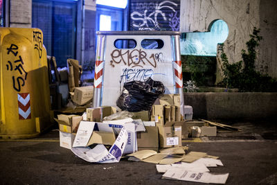 Garbage by bin at night