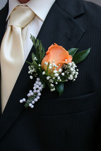 Close-up of bridegroom wearing boutonniere