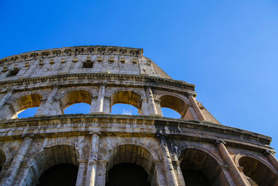 Low angle view of old building against blue sky