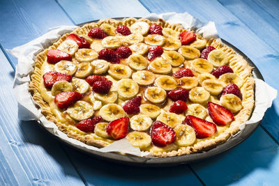 High angle view of strawberry banana tart served in plate on table