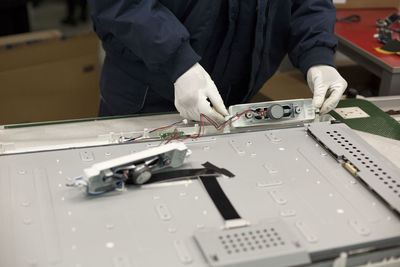 Midsection of man working in factory