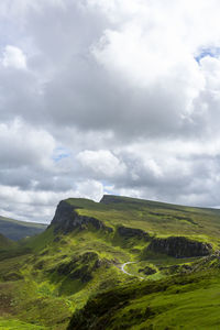 Road, cliffs, blue sky with clouds in quiraing isle of skye scotland