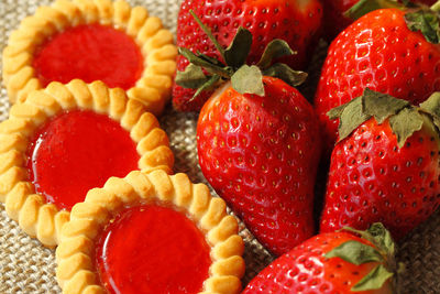 Close-up of strawberries and cookies on burlap