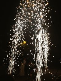 Low angle view of firework display at night