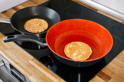 High angle view of panc with pancakes on stove at home