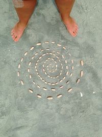 Low section of person standing on sand