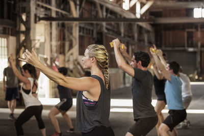 Male and female boxers practicing in gym
