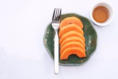 High angle view of fish on plate against white background