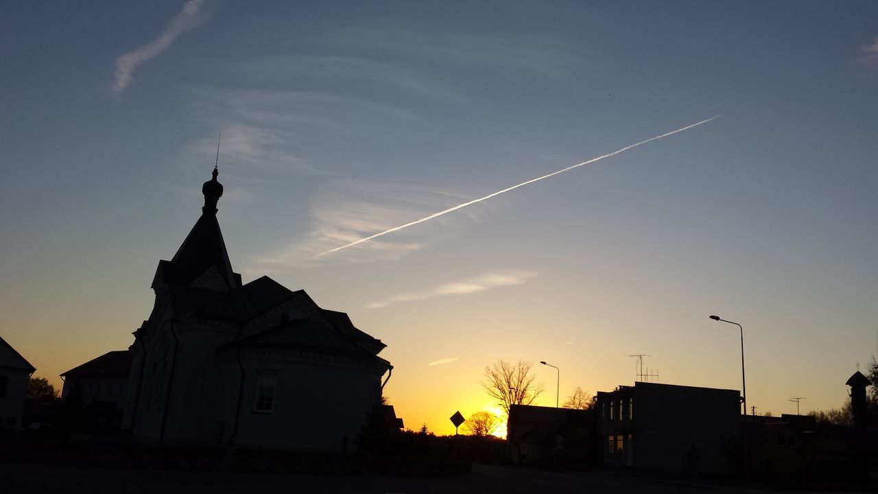 building exterior, architecture, silhouette, built structure, sunset, sky, low angle view, dusk, city, vapor trail, outdoors, house, cloud - sky, no people, building, cloud, street light, orange color, nature, residential structure