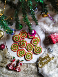 Pinwheel cookies are two different colors of dough, rolled up together, sliced, then baked