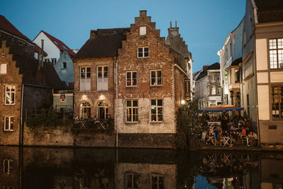 Buildings in city against clear sky