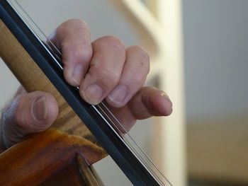 Close-up of man playing cello