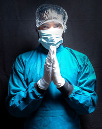 Portrait of a young man against blue background