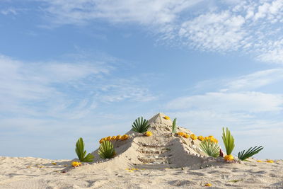 Low angle view of sand castle against sky