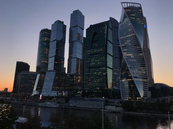 Low angle view of buildings against sky at dusk