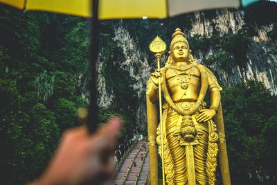 Statue of buddha against trees