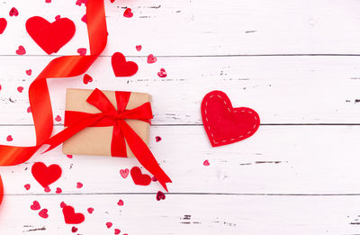 Directly above shot of red heart shape on white table