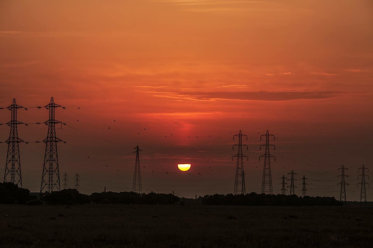 sunset, electricity pylon, orange color, sky, fuel and power generation, tranquility, tranquil scene, scenics, silhouette, sun, power line, beauty in nature, electricity, landscape, nature, power supply, field, idyllic, cloud - sky, technology