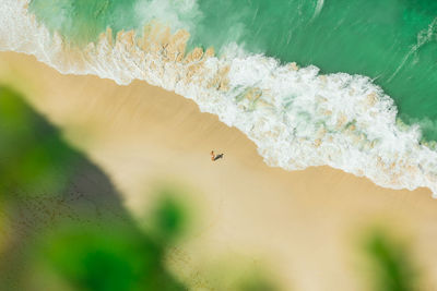 Aerial view of woman standing at seashore