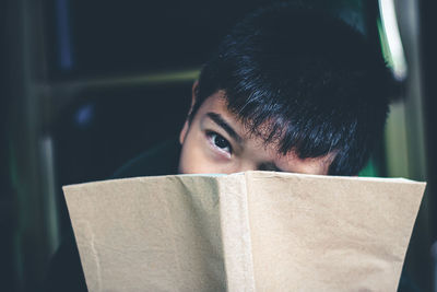 Close-up portrait of boy reading book