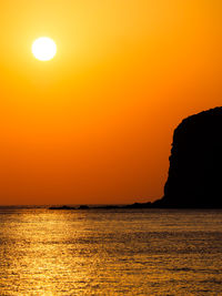 Scenic view of sea against romantic sky at sunset