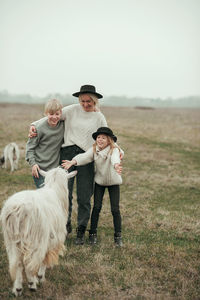 Side view of woman with horse on field