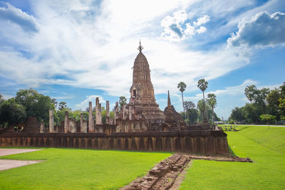 Temple by building against sky