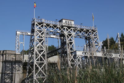 Low angle view of abandoned building against clear blue sky