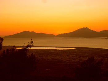 Scenic view of sea against orange sky