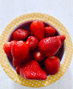 High angle view of strawberries in bowl on table